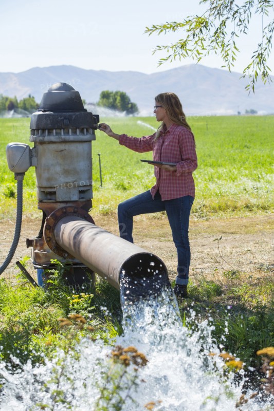 Caucasian farmer checking water pump