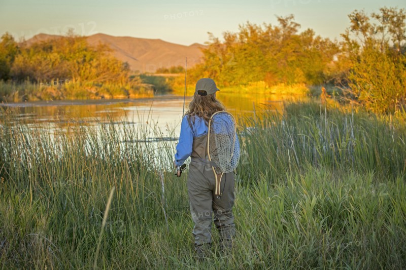 Caucasian woman with fishing gear at river