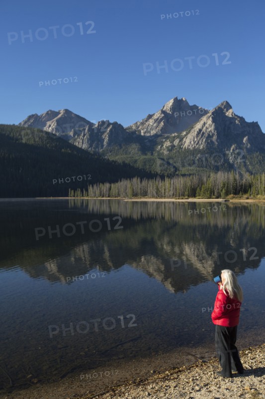 Caucasian woman admiring mountain and lake