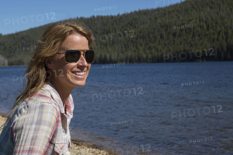 Caucasian woman sitting at remote river