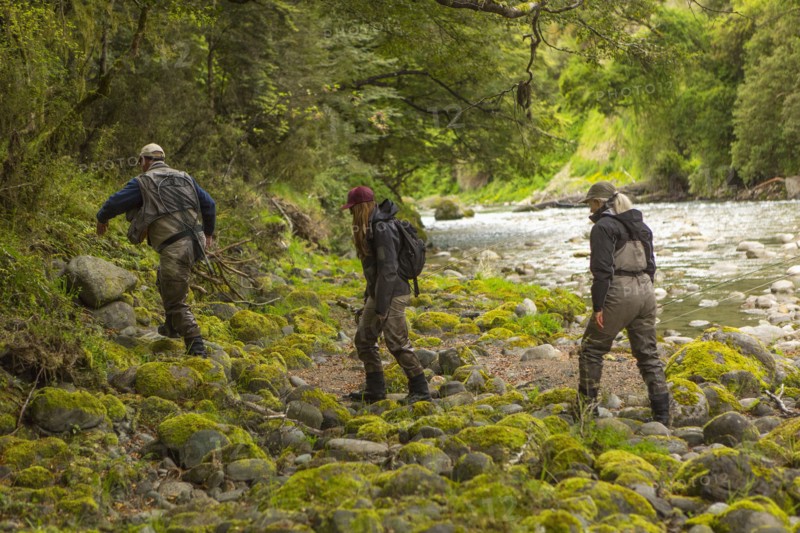 Caucasian friends walking in remote river