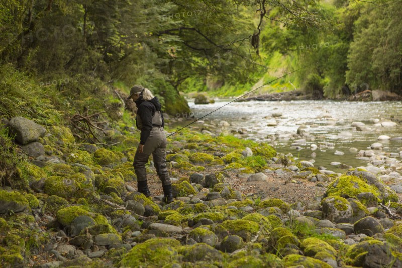 Caucasian woman walking in remote river