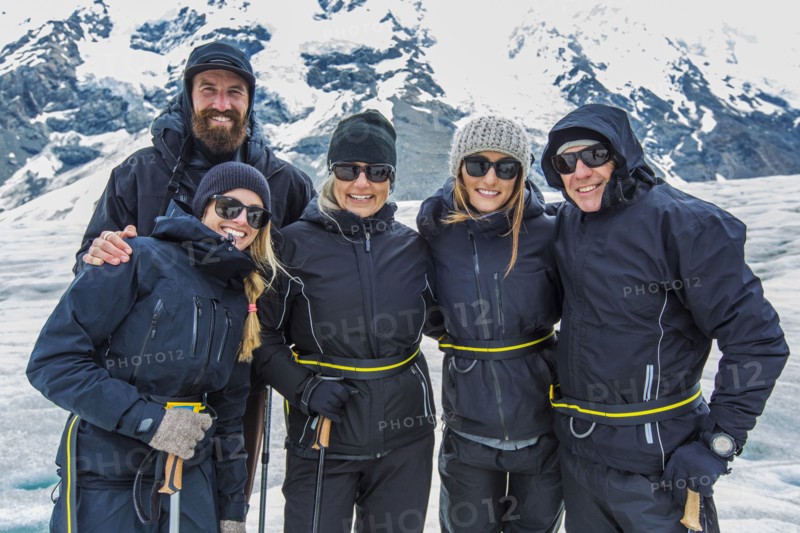 Caucasian cross-country skiers smiling in snowy landscape