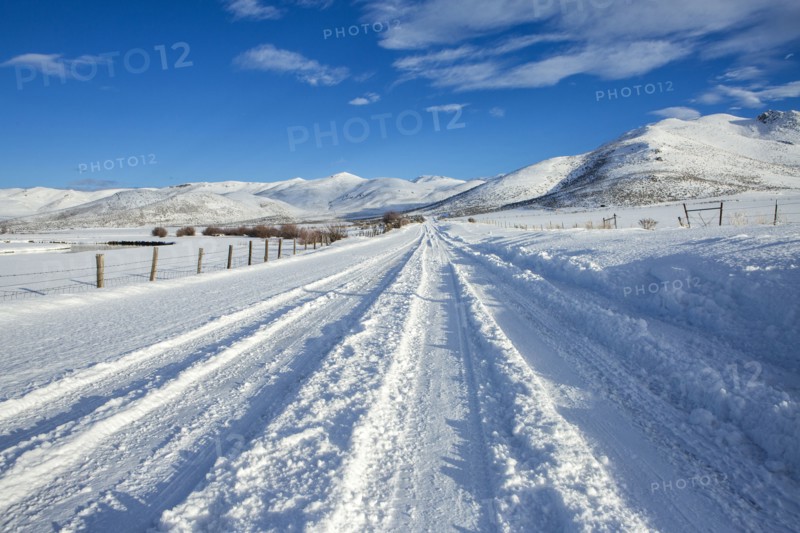 Tire tracks on snowy remote road