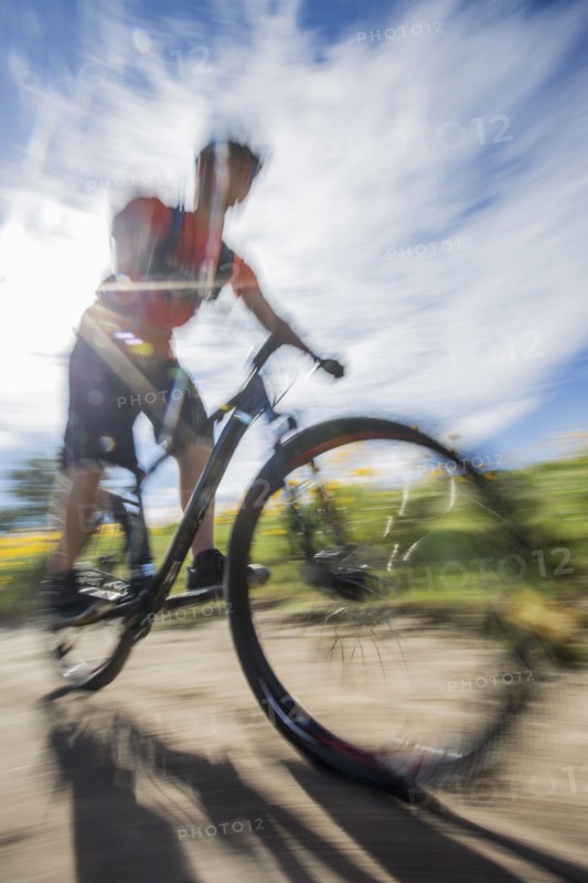 Blurred view of man riding mountain bike