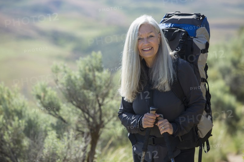 Older Caucasian woman hiking with backpack