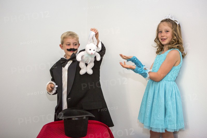 Caucasian magician pulling rabbit from hat