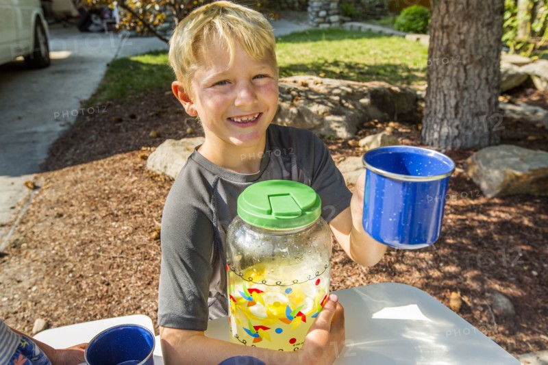 Smiling Caucasian boy posing with lemonade