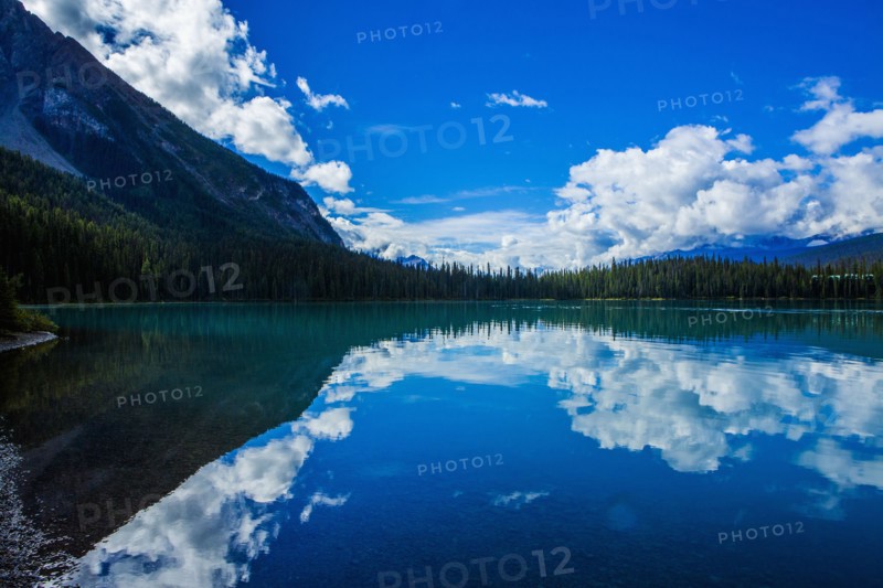 Reflection of clouds in still mountain lake
