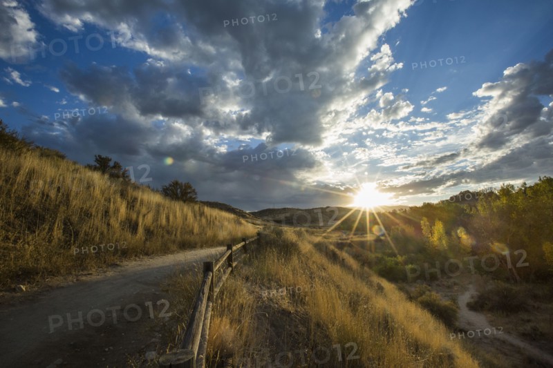 Sunset over distant mountain path