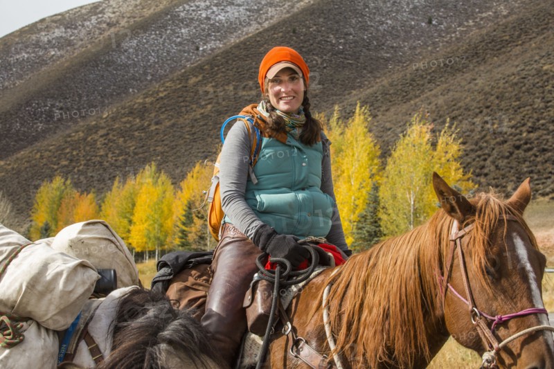 Smiling Caucasian woman riding horse in winter