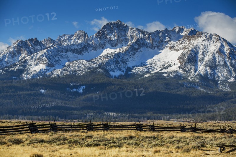 Wooden fence near snowy mountain