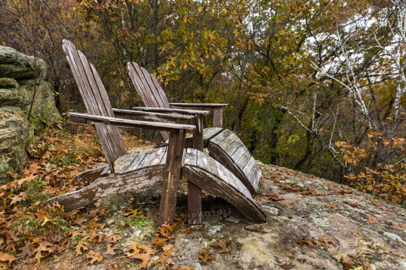 Autumn leaves near adirondack chairs