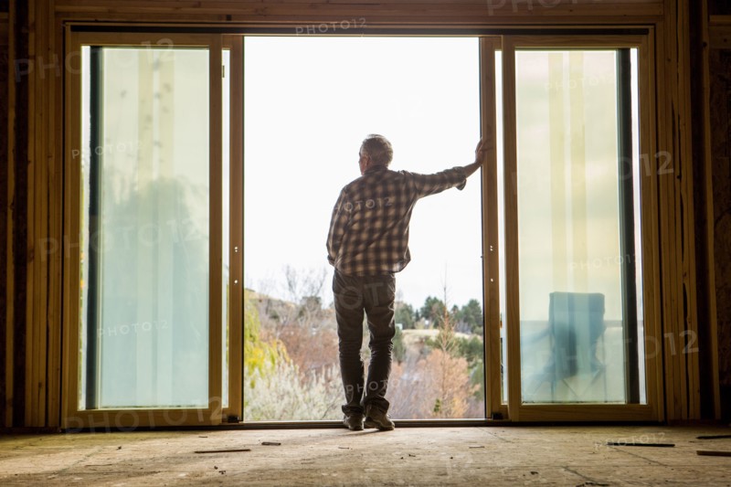 Caucasian man leaning in doorway