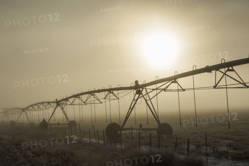 Irrigation equipment on farm in fog