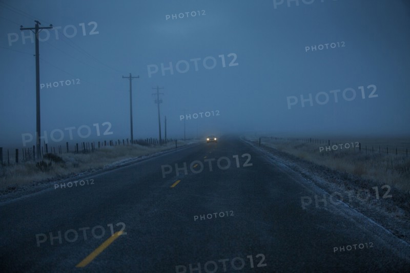 Car approaching on icy two-lane road
