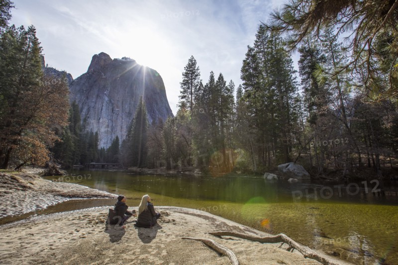 Caucasian couple sitting near river