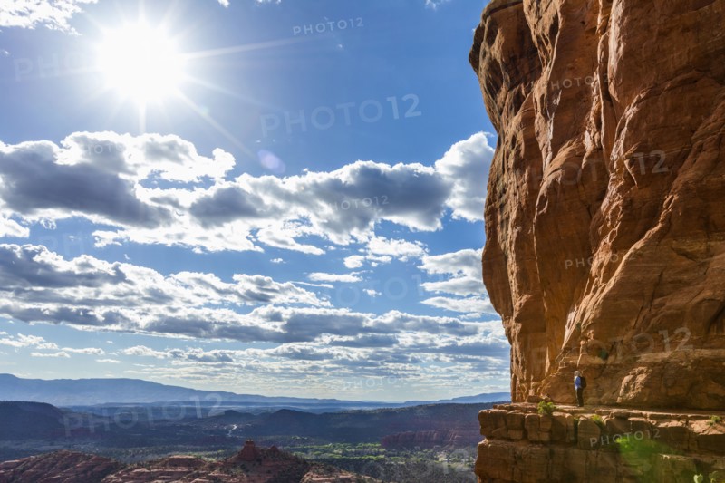 Caucasian woman hiking on ledge of cliff