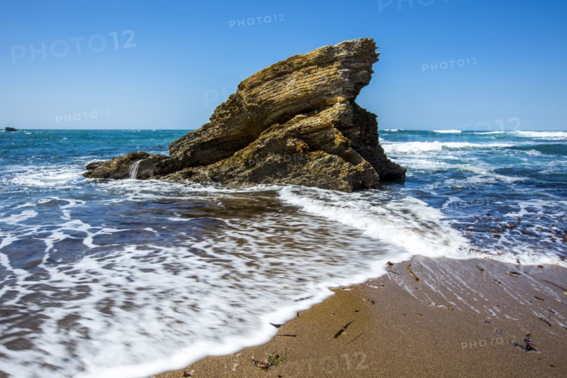 Waves splashing on rock at ocean beach