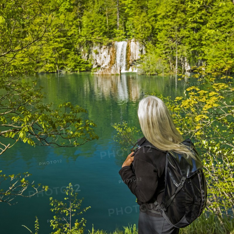 Older Caucasian woman admiring waterfall