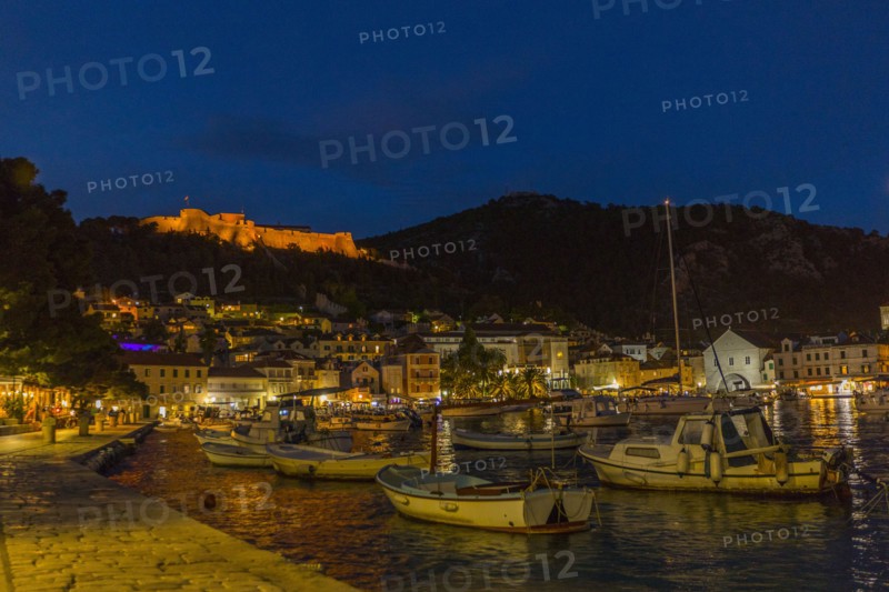 Scenic view of boats at waterfront at night