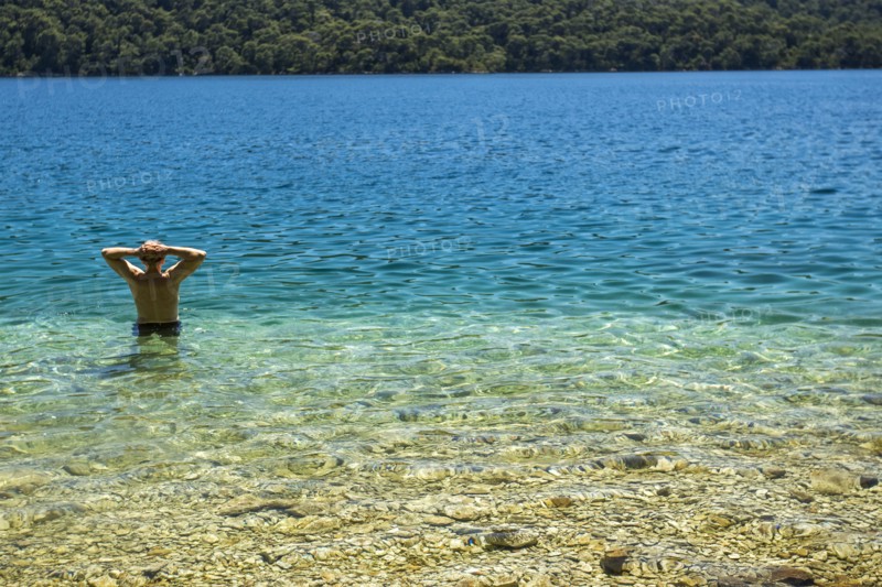 Caucasian man wading in water