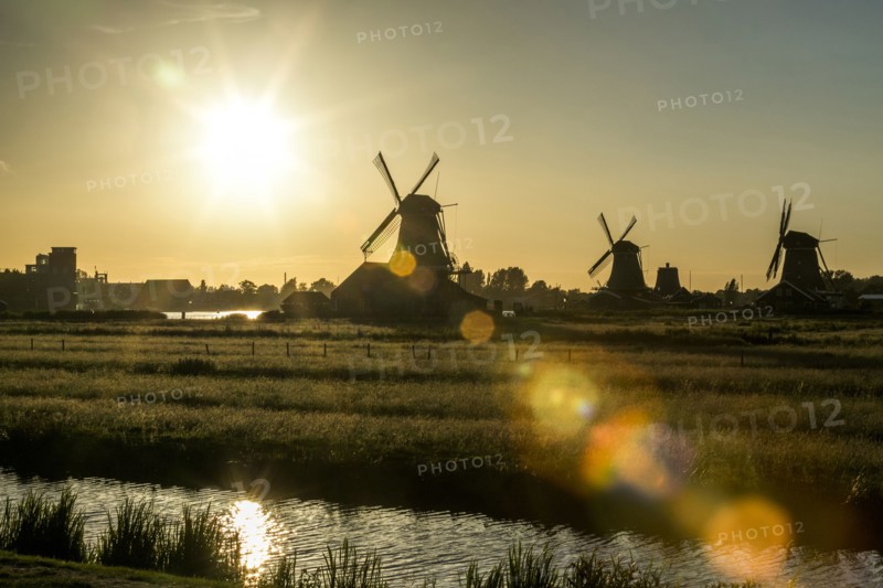 Silhouette of windmills at waterfront