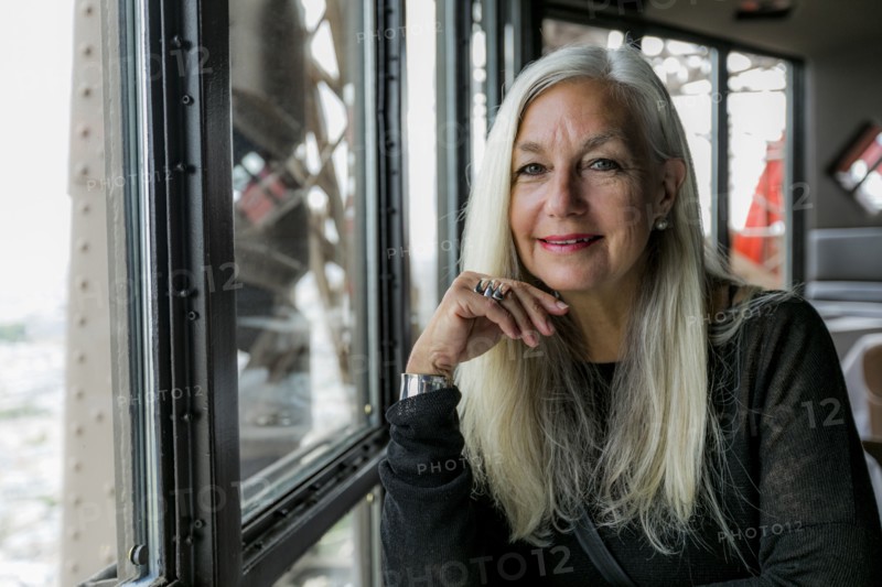 Portrait of smiling Caucasian woman near window