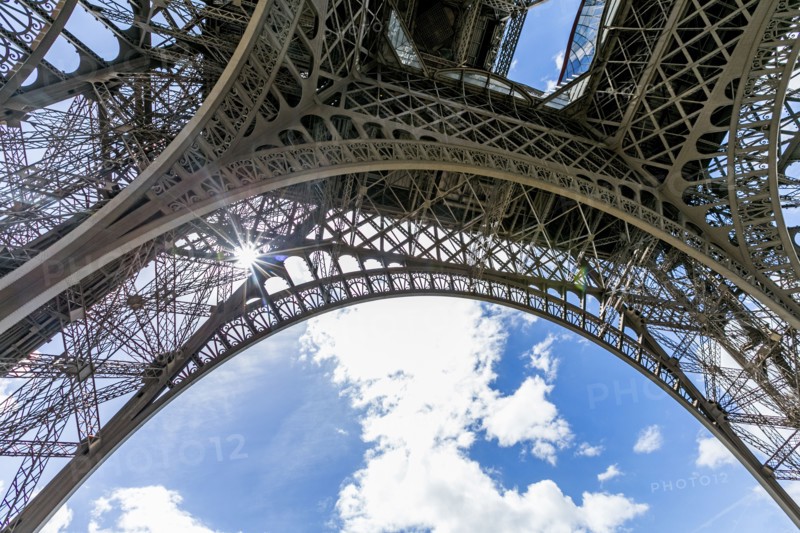 Sunbeams through metal beams of Eiffel Tower