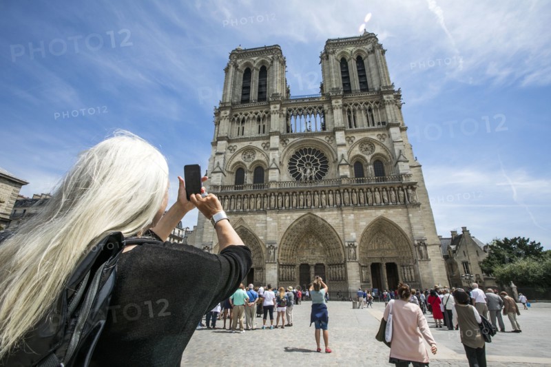 Caucasian woman photographing building
