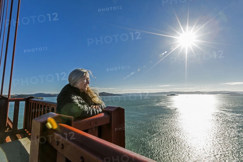 Caucasian woman admiring scenic view on bridge