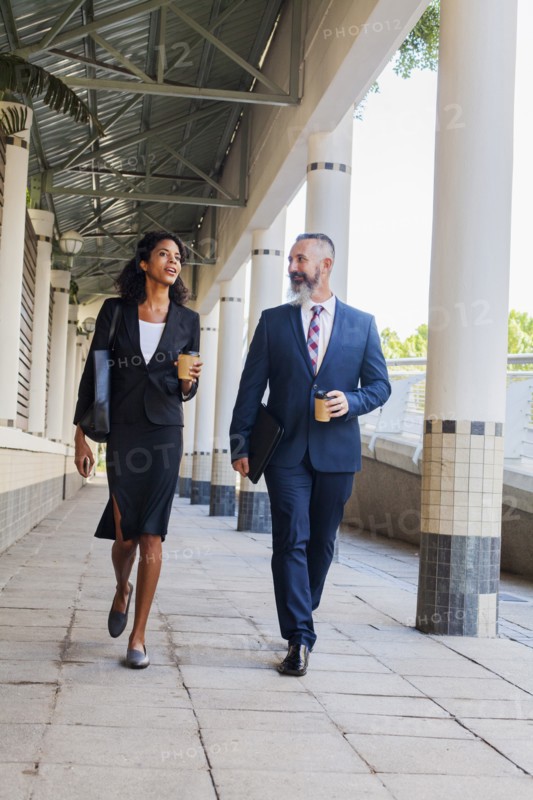 Business people walking on sidewalk