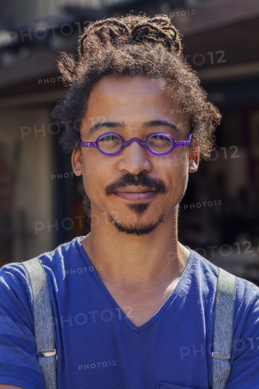 Serious mixed race man wearing suspenders