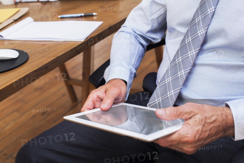 Hands of Caucasian businessman holding digital tablet