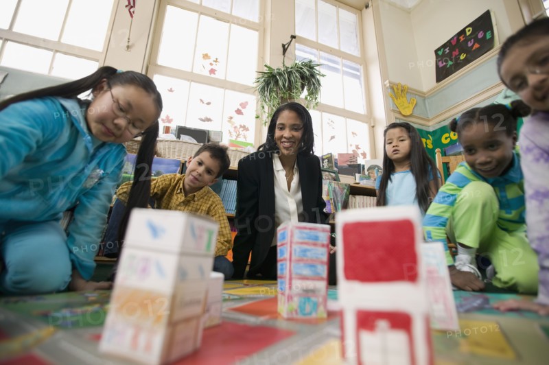 Multi-ethnic students in classroom with teacher