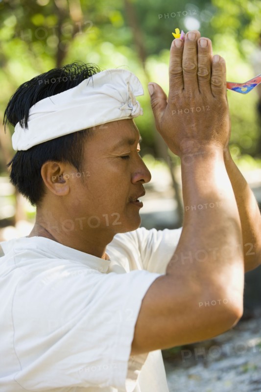 Asian man praying