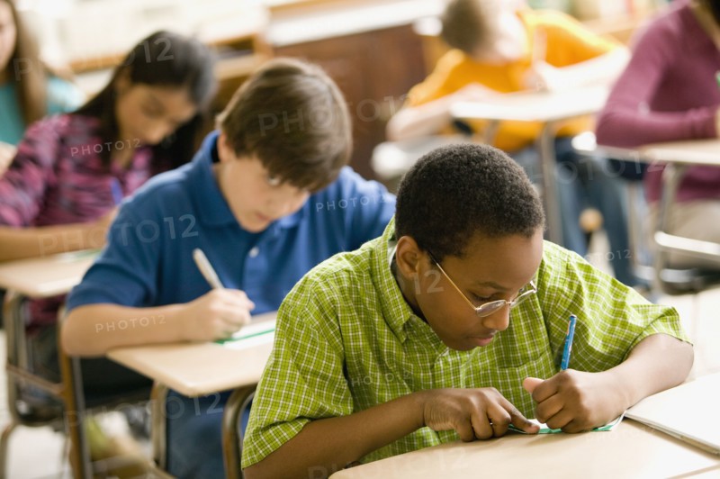Students making name cards in classroom
