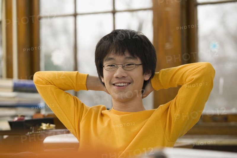 Asian student relaxing in classroom