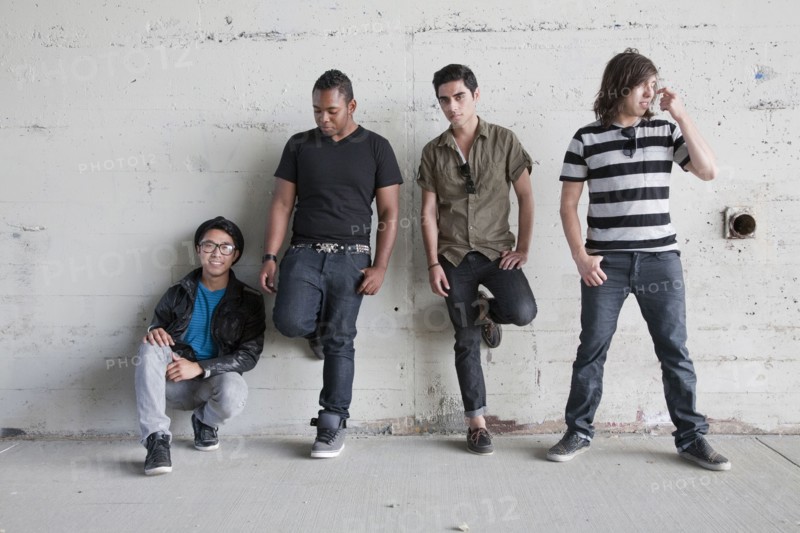Teenage boys leaning against wall