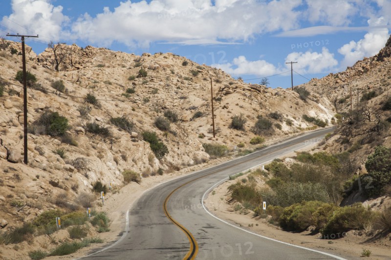 Empty road on rural desert hillside