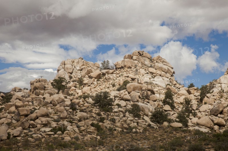Desert rock formations under cloudy sky