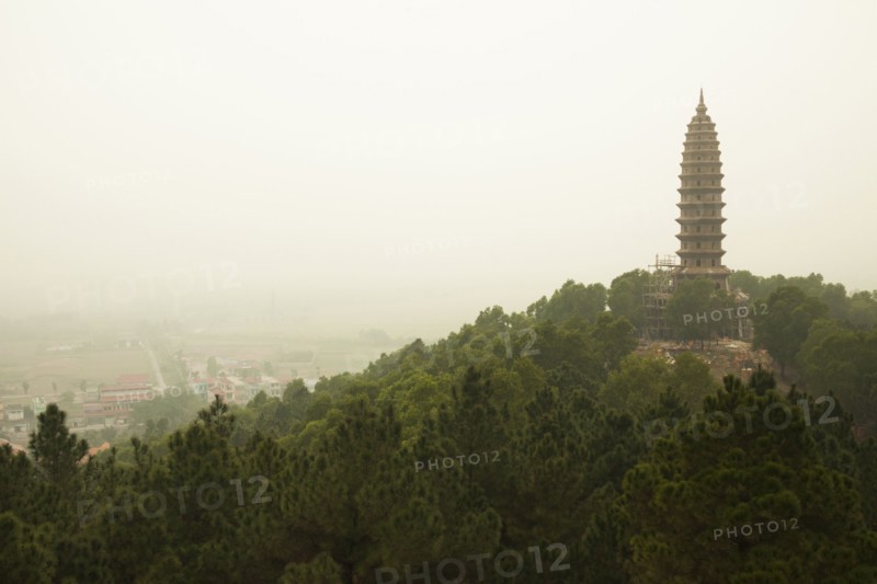 Buddhist temple tower on hilltop in remote landscape