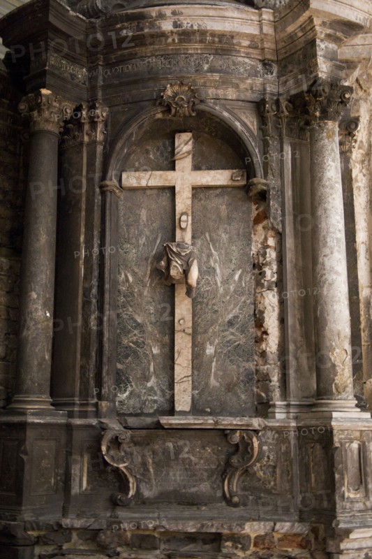 Crucifix on church wall above altar