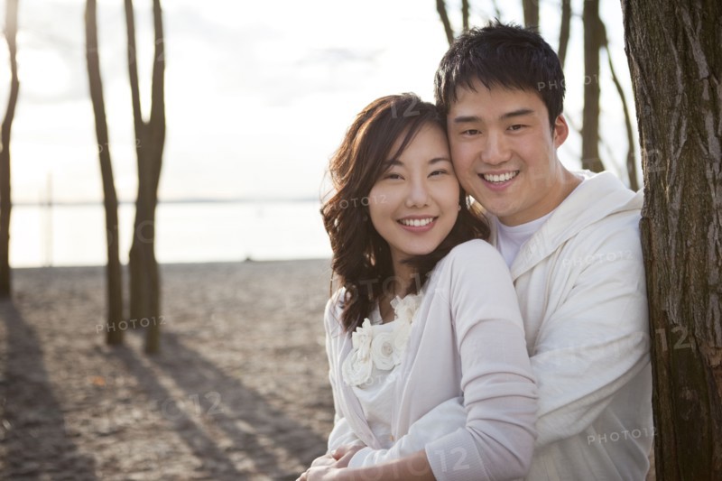 Korean couple hugging outdoors