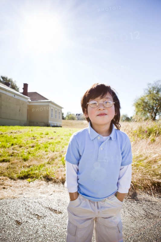 Chinese boy standing with hands in pockets