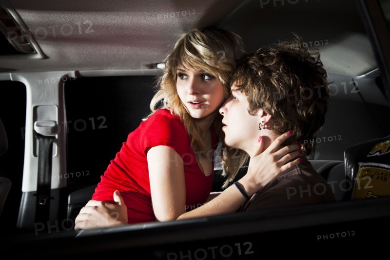 Couple making out in back seat of car