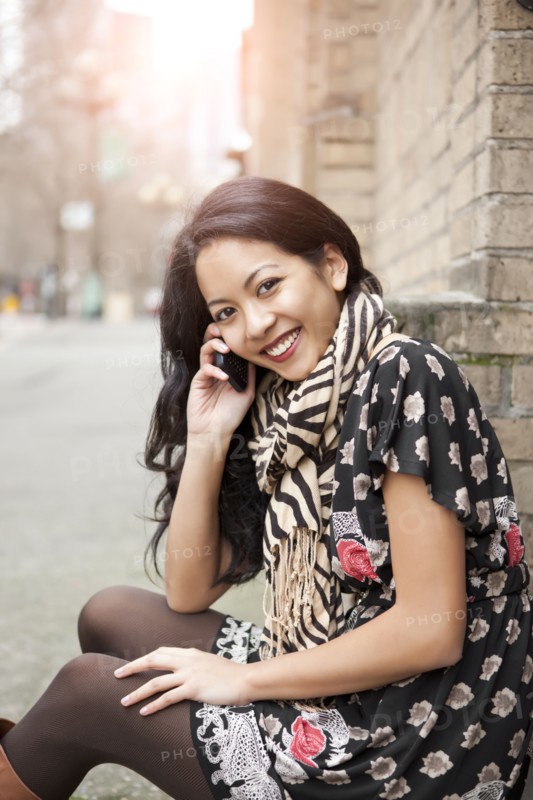 Mixed race woman talking on cell phone