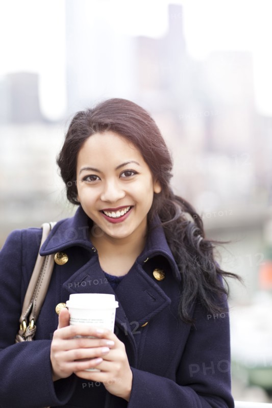 Mixed race woman drinking coffee