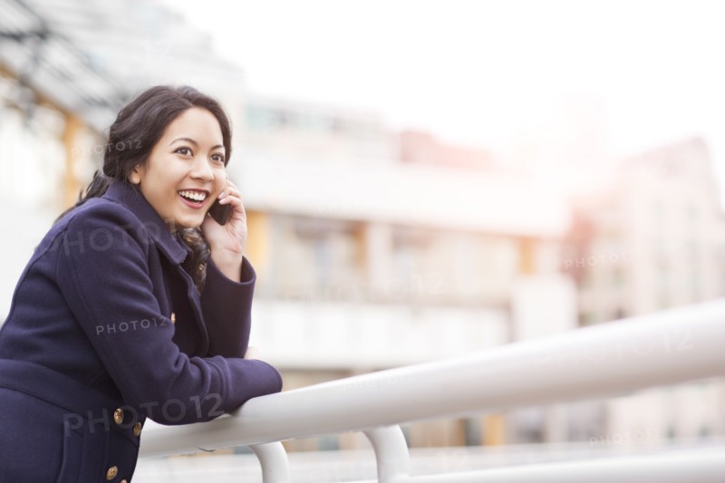 Mixed race woman talking on cell phone