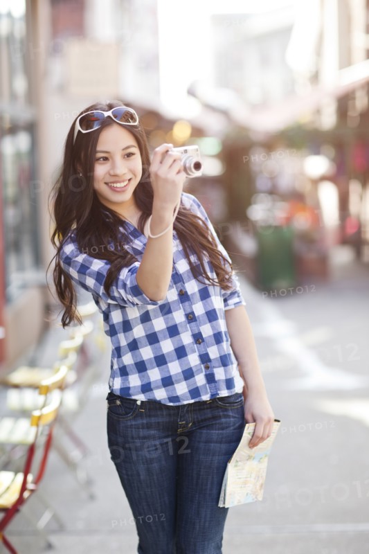 Chinese woman taking pictures with digital camera
